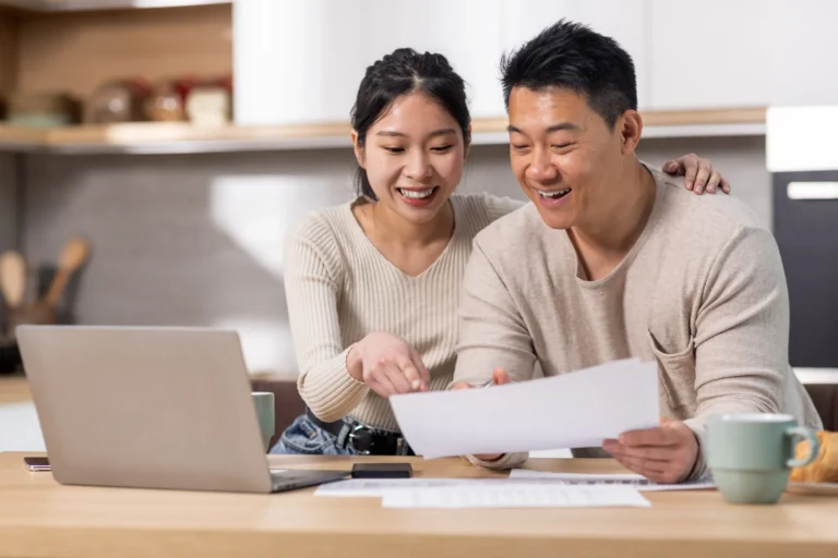 cheerful-asian-spouses-paying-bills-internet-using-laptop (Horizontal)
